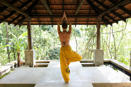 Woman practicing yoga in studio