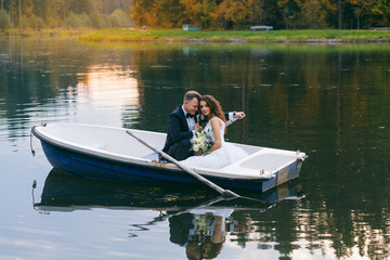 The bride and groom in a rowboat on the lake