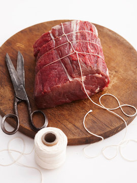 Twine wrapping raw beef