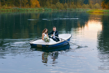 The bride and groom in a rowboat on the lake