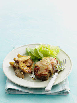 Plate of steak parmesan with potatoes