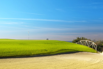 Green golf field on the sunny coast of Mediterranean sea