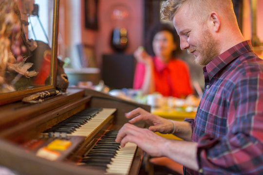 Smiling man playing organ