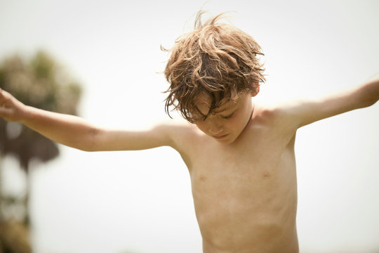 Bare-chested boy playing outdoors