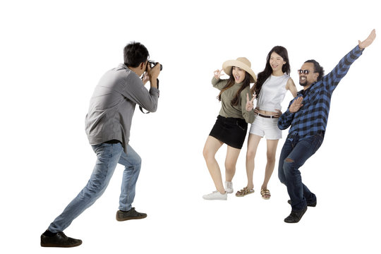 Asian man taking picture his friends on studio