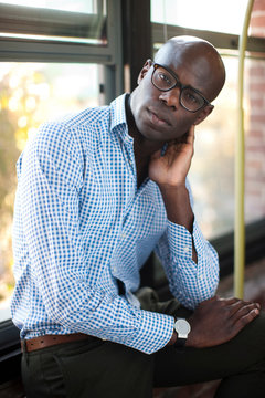 Businessman sitting on windowsill