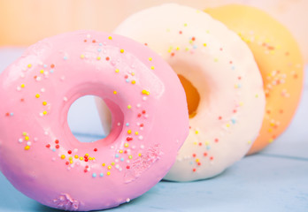 Colorful donuts on wooden table