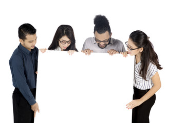 Business team looking at a blank banner