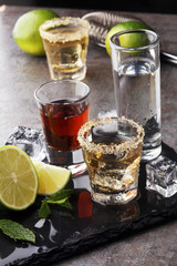 Selection of alcoholic drinks on rustic stone plate