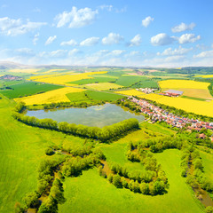 Aerial view to rural landscape with Uhlava river and fish pond. Luzany village near Pilsen in Czech Republic. Spring in Central Europe.