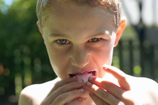 Boy biting into food