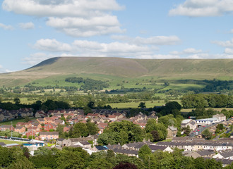 Fototapeta na wymiar Houses on the edge of Clitheroe, Lancashire with Pendle hill rising beyond.