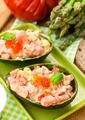 Stuffed avocado with tomato, garlic and mayonnaise