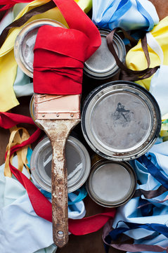 Still life of paint brush and multi colored textiles