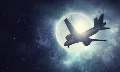 Obraz na płótnie Canvas Airliner in night sky . Mixed media