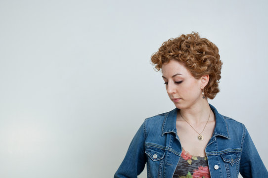 Young woman looking down, studio shot