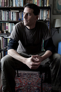 Seated man looking pensive