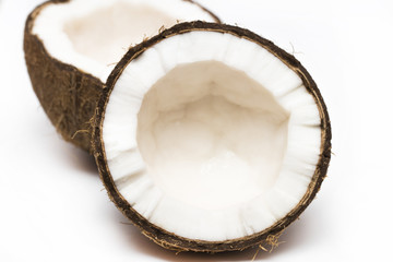 Coconut with a half on white background, closeup