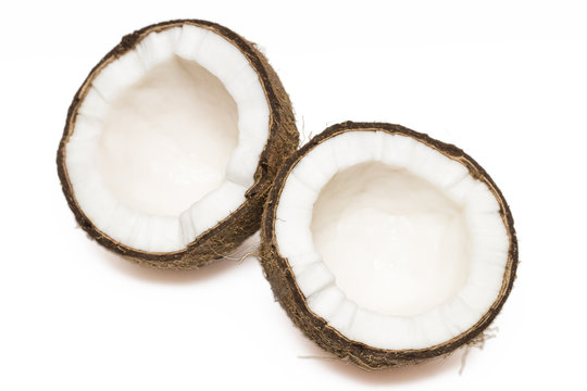 Coconut with a half on white background, closeup