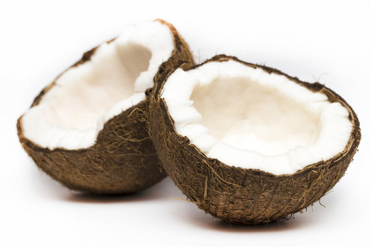 Coconut with a half on white background, closeup