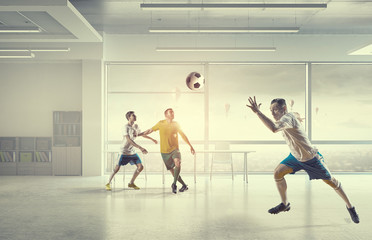 Playing football in office . Mixed media