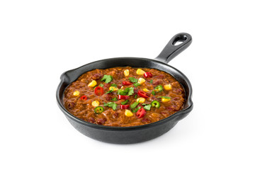 Traditional mexican tex mex chili con carne in a frying pan isolated on white background

