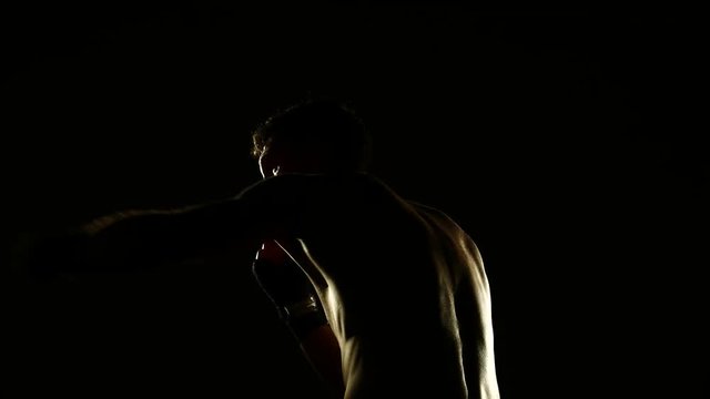 Boxer training in a gym, dramatic lighting. 4k