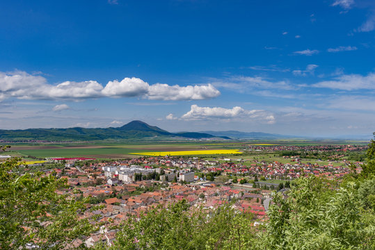Spring view over Rasnov city, in Brasov county (Romania), with Codlea mountain in the background and with Cristian village in the far right
