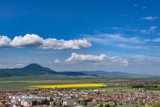 Spring view over Rasnov city, in Brasov county (Romania), with Codlea mountain in the background and with Cristian village in the far right