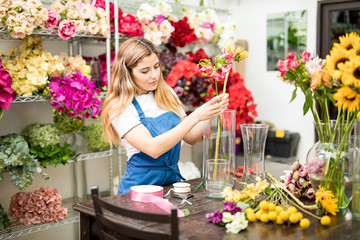 Woman putting flowers inside a vase