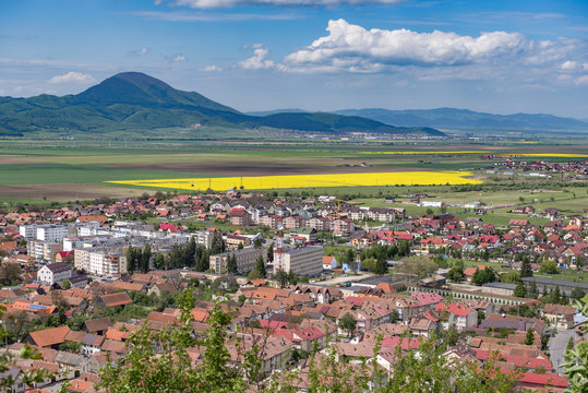 Spring view over Rasnov city, in Brasov county (Romania), with Codlea mountain in the background and with Cristian village in the far right