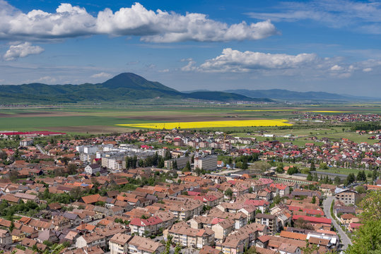 Spring view over Rasnov city, in Brasov county (Romania), with Codlea mountain in the background and with Cristian village in the far right