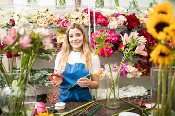 Female florist working on a flower arrangement
