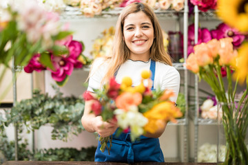 Happy florist showing her work