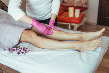 Sugaring Sugar waxing feet in the beauty salon.