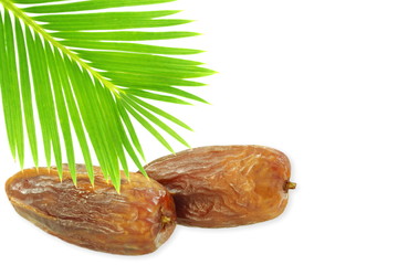 Date fruits with palm leaves on white background