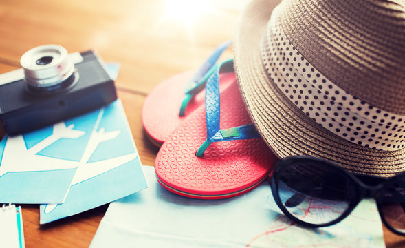 close up of travel map, flip-flops, hat and camera