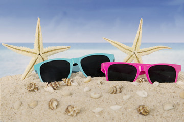 Fototapeta na wymiar Sunglasses and starfish on beach
