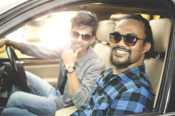 Two young men sitting in the car