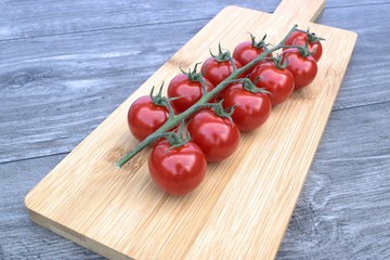Cherry tomatoes on a cutting board and a wooden background.