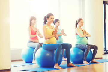 Fototapeta na wymiar happy pregnant women exercising on fitball in gym