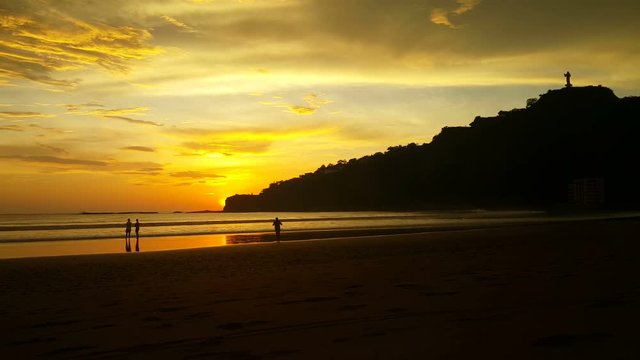 Man takes picture of sunset at the beach of San Juan del Sur