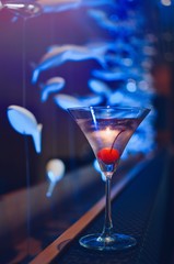 cocktail in martini glasses in front of the night club bokeh lights. Party and celebrate concept 