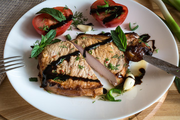 Cut pork steak with sauce, mint, garlic and sliced tomato