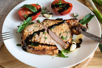 Cut pork steak with sauce, mint, garlic and sliced tomato