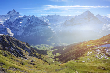 Obraz premium Stunning landscape of green grass Alp mountains with sun shine warm flare in daylight autumn, Switzerland