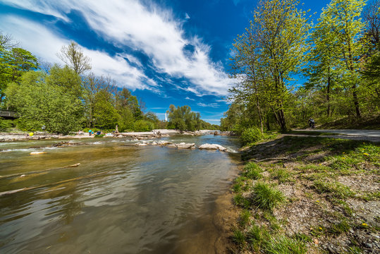 Flaucher an der Isar in M&uuml;nchen unter wei&szlig;-blauem Himmel