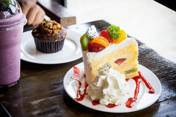 fruit cake muffin dessert and sweet beverage in cafe