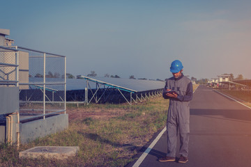 electrician working on checking status inverter and maintenance equipment at green energy solar...