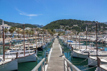 Latin sailing ships, are lined up on the jetty. Marina view port in balearic village of Port-Soller, Majorca island, Balearic Islands, Spain.